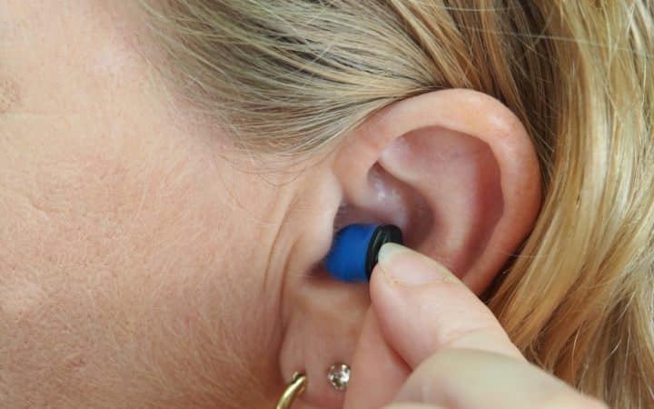 woman wearing blue stud earring